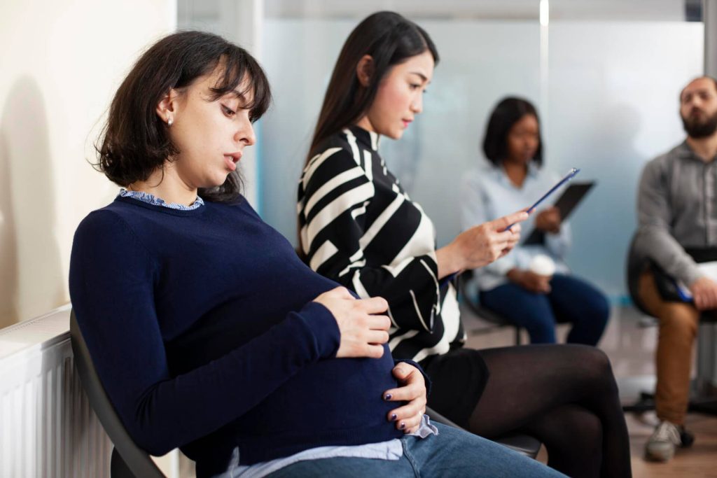 Pregnant Nevada employee discussing workplace discrimination and accommodation rights with employment attorney