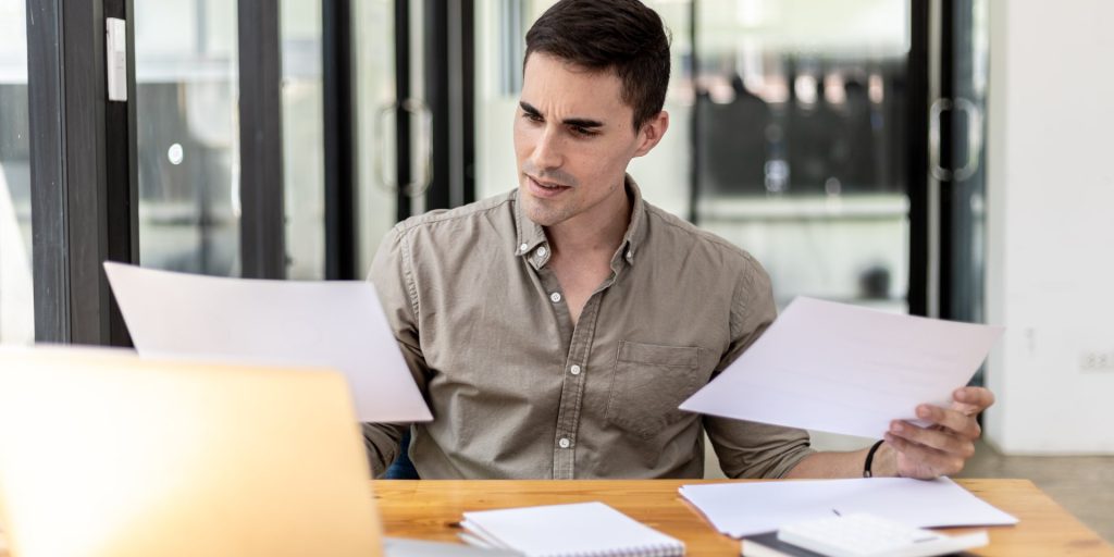 how-to-prove-wrongful-termination-nevada Employee reviewing evidence for a wrongful termination claim in Nevada