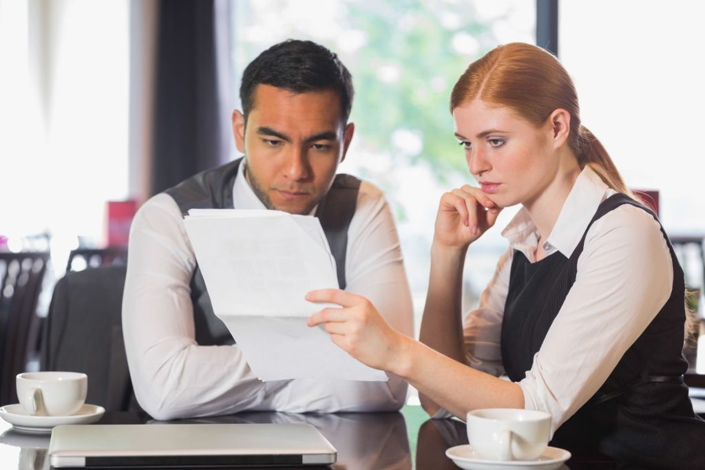 Nevada employment attorney reviewing tip-pooling and wage records with a hospitality worker