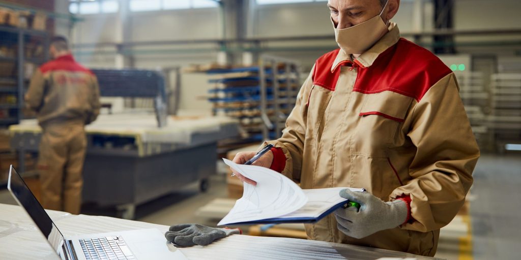 Reno warehouse worker reviewing workplace rights and pay records