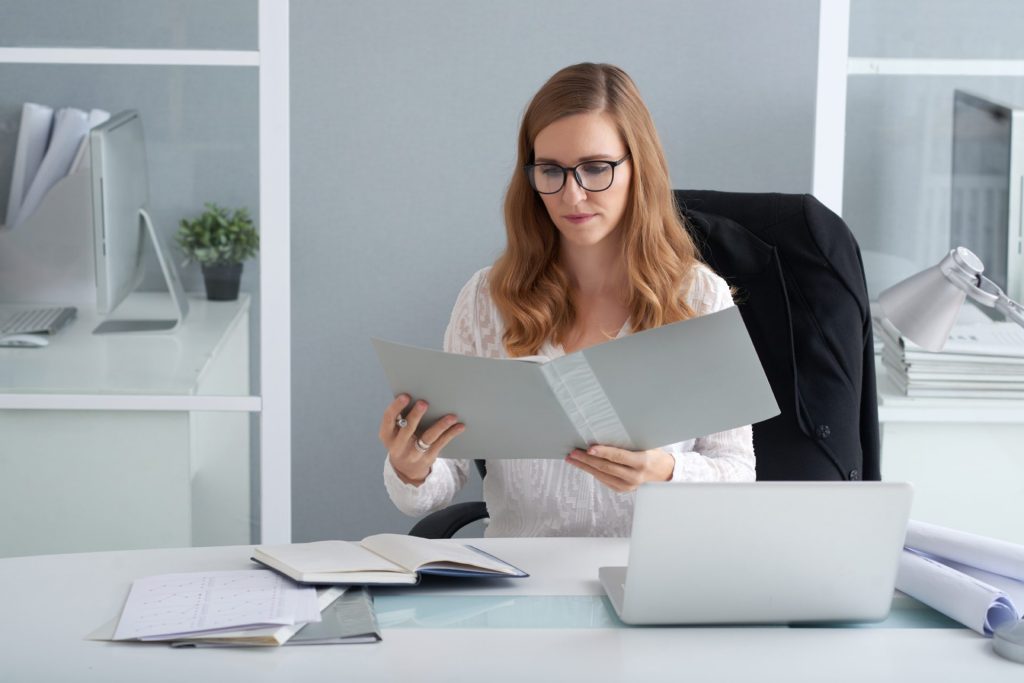 Employee reviewing documents after being fired for reporting a workplace safety violation in Nevada