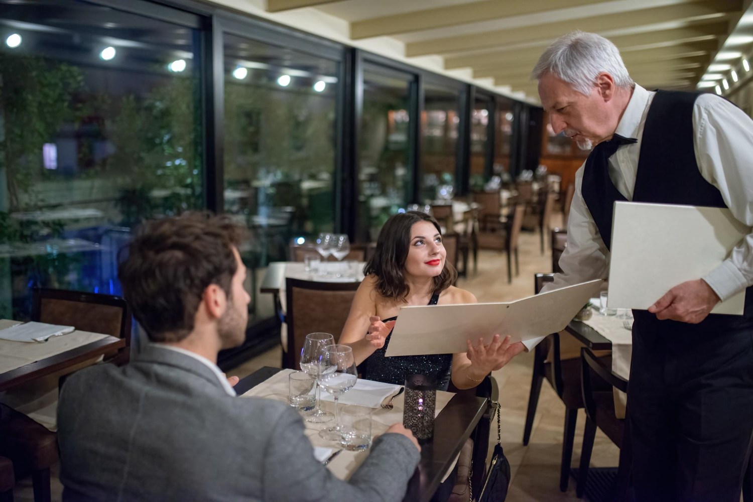 Restaurant and banquet staff reviewing service charge invoices and pay records to understand tip distribution and employee rights under California employment law.