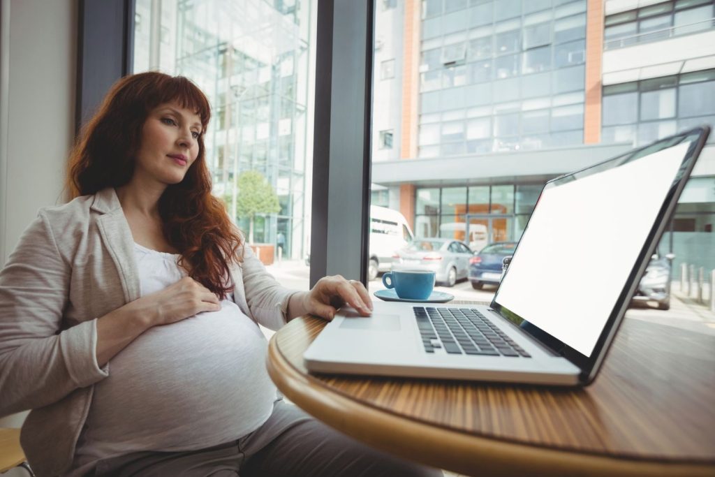 Pregnant employee reviewing termination documents and employment rights in California