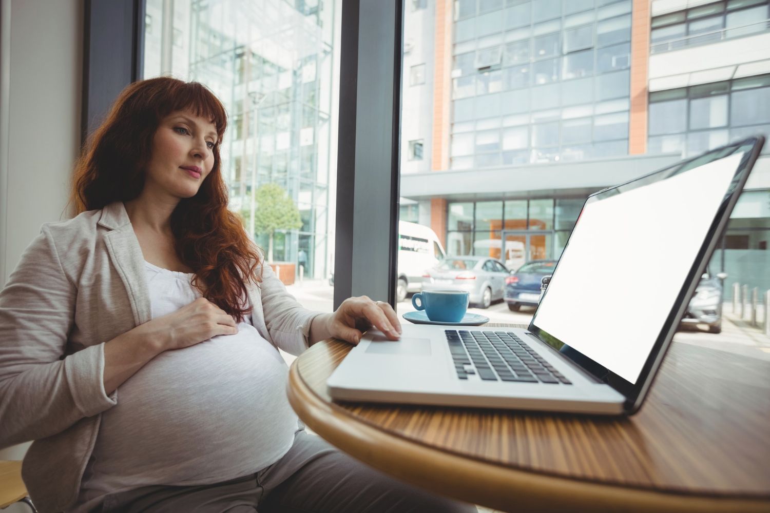 Pregnant employee reviewing termination documents and employment rights in California