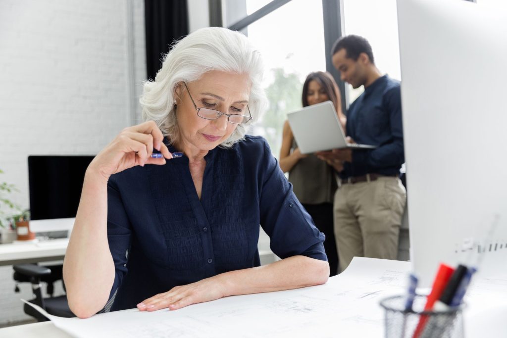 Older California employee reviewing workplace documents for age discrimination