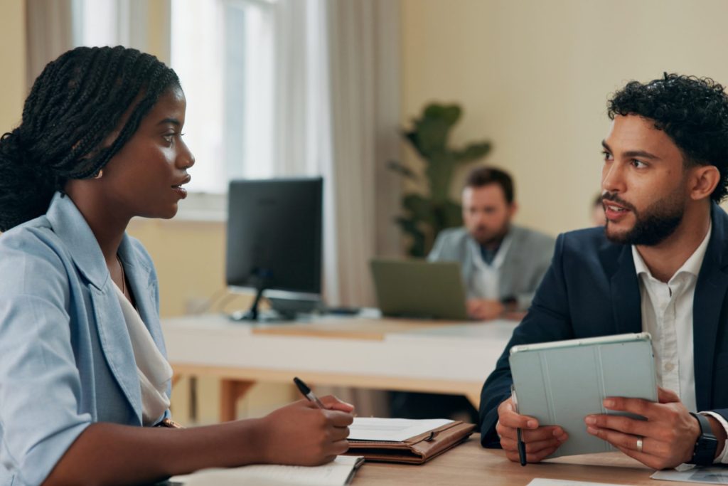 California employee with braids reviewing workplace grooming policy and CROWN Act rights
