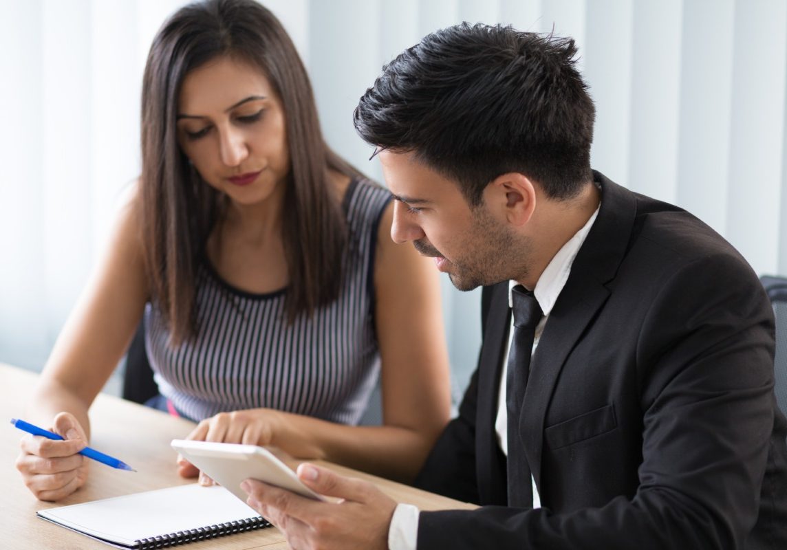 Nevada employee reviewing a denied unemployment benefits decision with an employment attorney