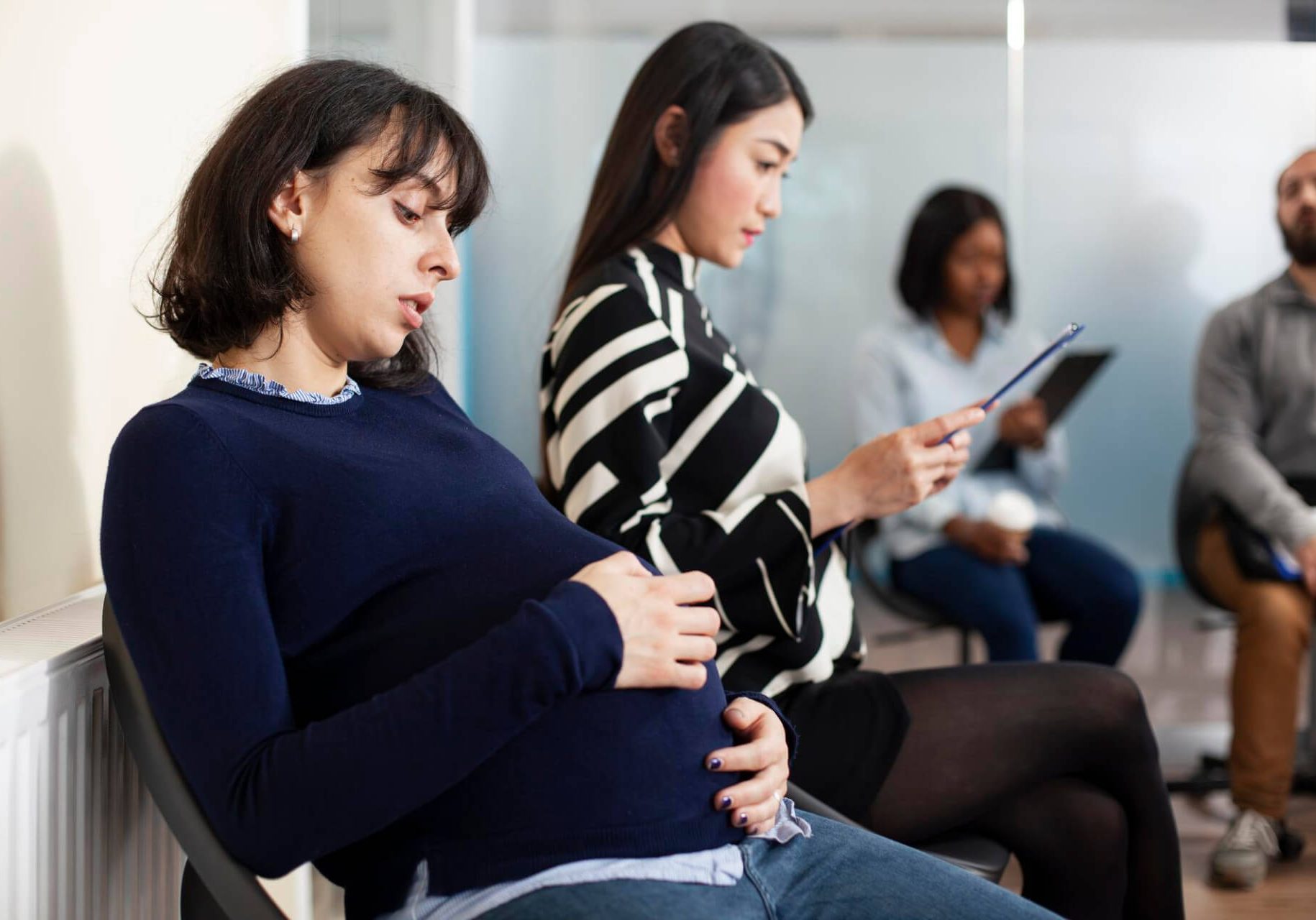 Pregnant Nevada employee discussing workplace discrimination and accommodation rights with employment attorney